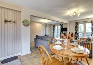 a dining room and living room with a table and chairs at Barn Owl Retreat Sibton in Sibton