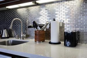 a kitchen counter with a sink and a roll of paper towels at Urban Loft Apartment in Los Angeles