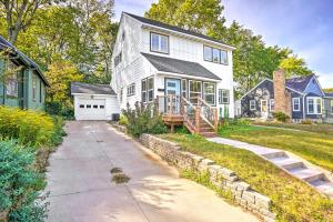 a white house with a porch and a driveway at Pet-Friendly Minneapolis Home about 6 Mi to Dtwn! in Minneapolis