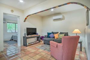 a living room with a couch and a tv at Charming Tucson Casita Near Hiking and Biking! in Tucson