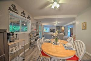 a kitchen and dining room with a wooden table and chairs at Lovely Snohomish Studio Near Boating and Hiking in Snohomish