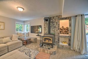 a living room with a stone wall with a fireplace at Lovely Snohomish Studio Near Boating and Hiking in Snohomish