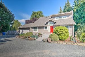 a house with a red door on a driveway at Lovely Snohomish Studio Near Boating and Hiking in Snohomish