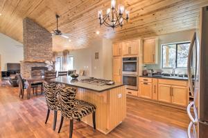 een keuken met houten kasten en een tafel met stoelen bij Pine Mountain Club Home with Beautiful View! in Frazier Park