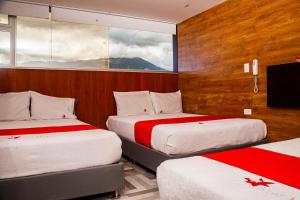 a hotel room with two beds and a window at Hotel Star Pasto in Pasto