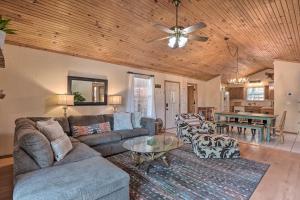 a living room with a couch and a table at Lush Garfield Cabin with Community Pool and Lake! in Garfield