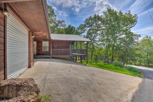 a house with a porch and a driveway at Lush Garfield Cabin with Community Pool and Lake! in Garfield