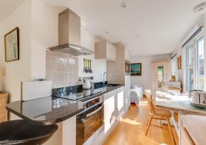 a kitchen with a black counter top in a room at The Studio in Waldringfield