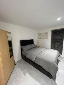 a bedroom with a large bed and a window at Orion building apartments ,OPOSITE GRAND CENTRAL,FREE CAR PARK in Birmingham