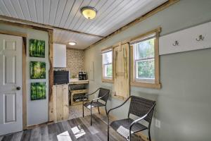 a living room with two chairs and a kitchen at Explore New River Gorge: Quiet Couple’s Retreat in Hico