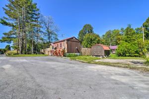 una strada vuota con un fienile e una casa di Mt Lookout Tiny House with Backyard and Fire Pit! a Hico