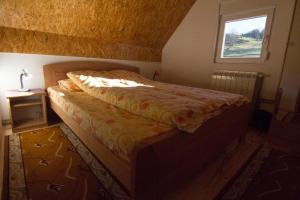 a bedroom with a bed and a window at Guest House Happy in Žabljak