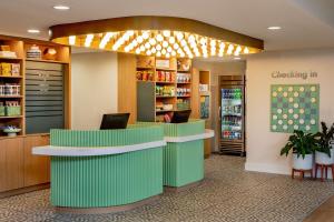 a waiting room with a green counter in a store at Sonesta Select Boston Foxborough Mansfield in Foxborough
