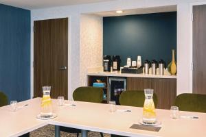 a meeting room with tables and chairs with glasses at Sonesta Select Boston Foxborough Mansfield in Foxborough