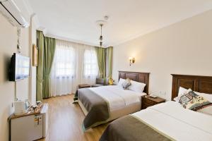 Postel nebo postele na pokoji v ubytování Hadrian Gate Hotel + 37 fotografií