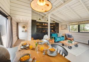 a dining room with a table with food on it at The Cowshed in Crowfield