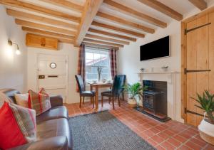 a living room with a couch and a table at Lime Quay Cottage in Woodbridge