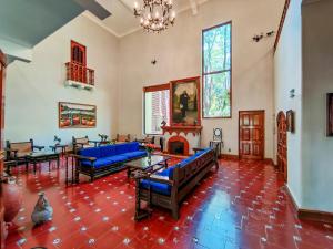 a living room with blue couches and a fireplace at Rancho La Joya in Xochitepec