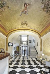 a man standing in the hallway of a building with a ceiling at Palazzo Pischedda in Bosa