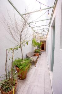 a corridor with benches and potted plants in a building at Casa Savana in São Paulo