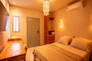 a bedroom with a bed and a table and a window at Casa Savana in São Paulo