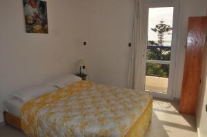 1 dormitorio con cama y ventana grande en Résidence La Galiote, en Essaouira