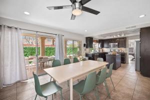 a kitchen and dining room with a table and chairs at Golden Desert Getaway Family Friendly Home in Indio