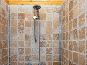 a shower in a bathroom with a brick wall at Holiday home Toftlund XLIV in Toftlund