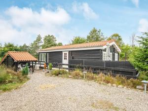 a small black house with a roof at Holiday home Toftlund XLIV in Toftlund