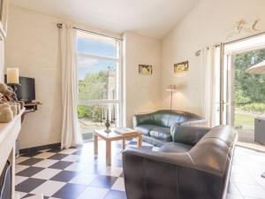 a living room with a couch and a table at Gîte de charme avec piscine chauffée et WiFi - 2 chambres - FR-1-306-803 in Châteauthébaud