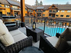 a patio with chairs and a table with a bottle of wine at Ultimate Luxury Residence with Extras Galore across from Heavenly Village & Gondola - Zalanta Resort in South Lake Tahoe