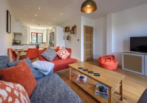 a living room with a couch and a table at 7 Pen y Bont in Abersoch