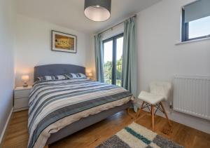 a bedroom with a bed and a window at 7 Pen y Bont in Abersoch