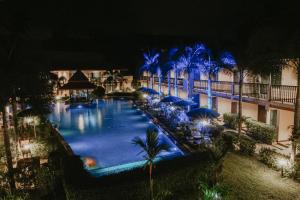 ein Pool in der Nacht mit blauen Lichtern in der Unterkunft Chivatara Resort Bang Tao Beach Phuket - SHA in Strand Bang Tao