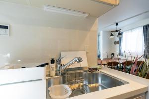 a kitchen with a stainless steel sink in a kitchen at SHIBUYA TOKYO in Tokyo