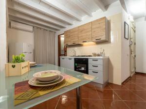 a kitchen with a table with a bowl on it at Dimore Castello in Cagliari