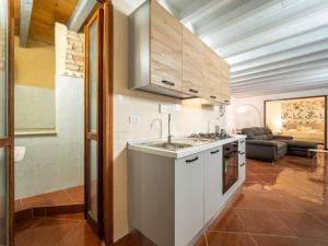 a kitchen with a sink and a couch in a room at Dimore Castello in Cagliari