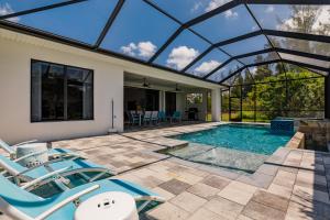 una piscina con sillas y una casa en Villa Aviator, en Cabo Coral