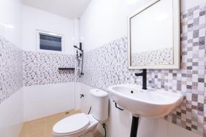 a bathroom with a sink and a toilet and a mirror at Amaz Villa in Ban Nang Lae +18 photos