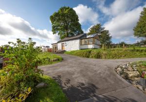 a house on a hill with a driveway at Beudy Bach in Llanrwst