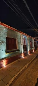 a building with a door on a street at night at Atlantic Hospedagem in São Sebastião