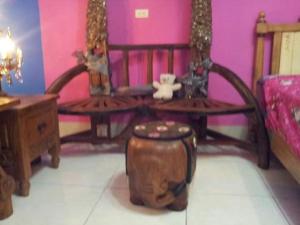 a room with two benches and a table and a stool at Hualien Seaside B&B in Hualien City