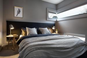 a bedroom with a large bed and a window at Haven in Daylesford
