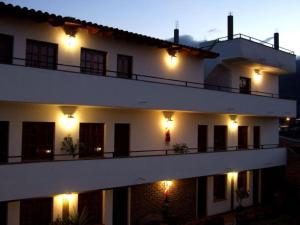 a large white building with lights on the side of it at Cerro de la Cruz in Cafayate