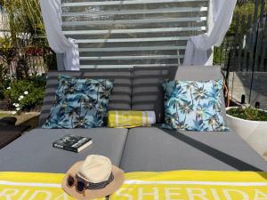 a hat and a book sitting on a bed at Mulwala Resort in Mulwala