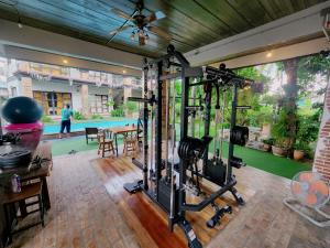 a gym with exercise equipment in a house at Above The Sea Maesariang in Mae Sariang
