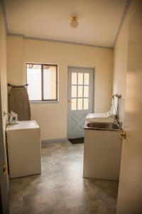 an empty room with a sink and a door at Cherry Lane Apartments in Bright