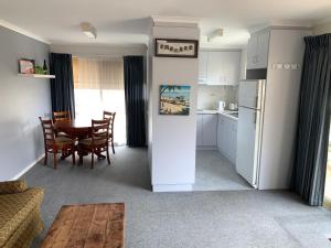 a kitchen and dining room with a table and chairs at Portarlington Holiday Apartment in Portarlington