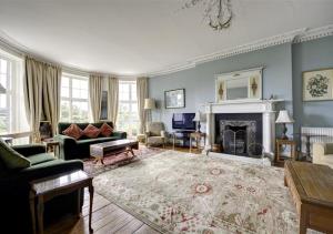 a living room filled with furniture and a fireplace at Clynderwen House in Pembroke