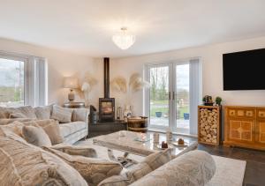 a living room with a couch and a tv at Cluniac Cottage in Menai Bridge